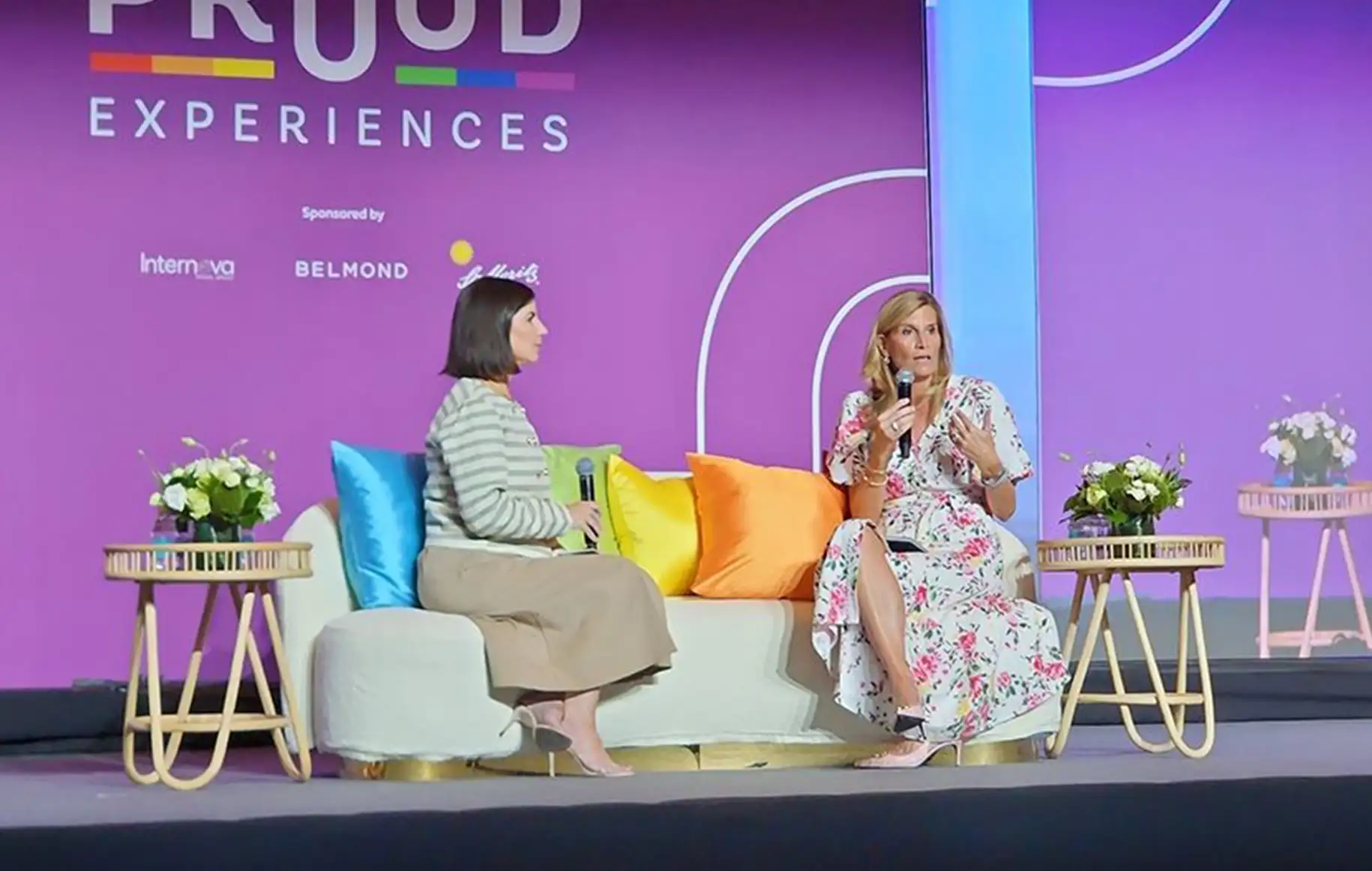 Kim sitting on cough being interviewed at Proud Experience